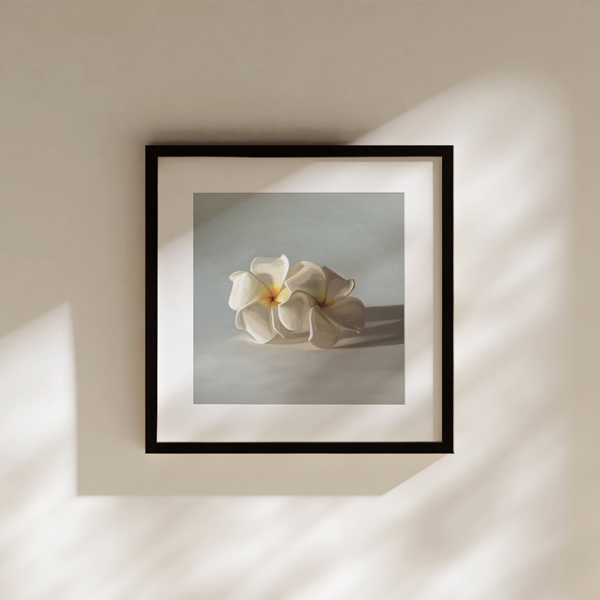 This artwork features a pair of white plumeria blossoms resting on a light bluegrey surface.