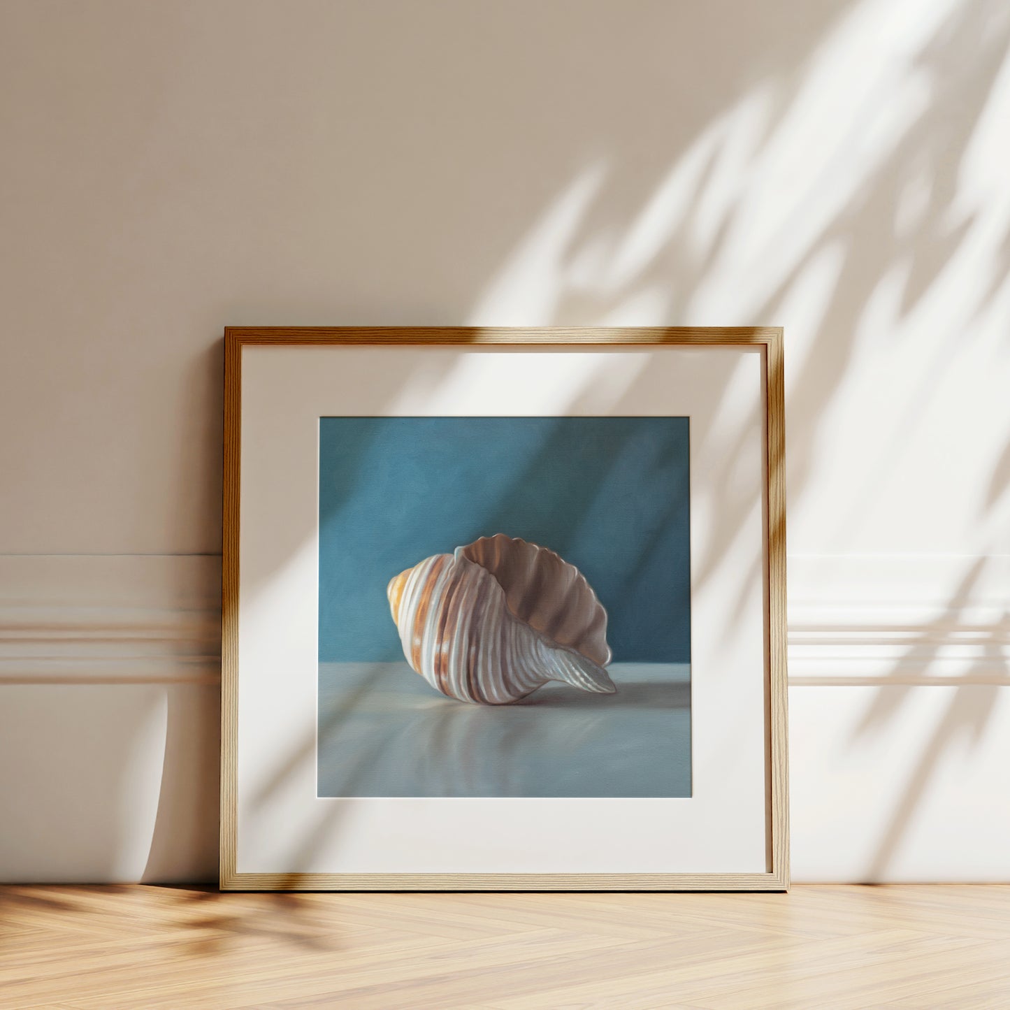 This artwork features yet another single seashell resting on a light surface with dramatic lighting and a soft mutedblue background.