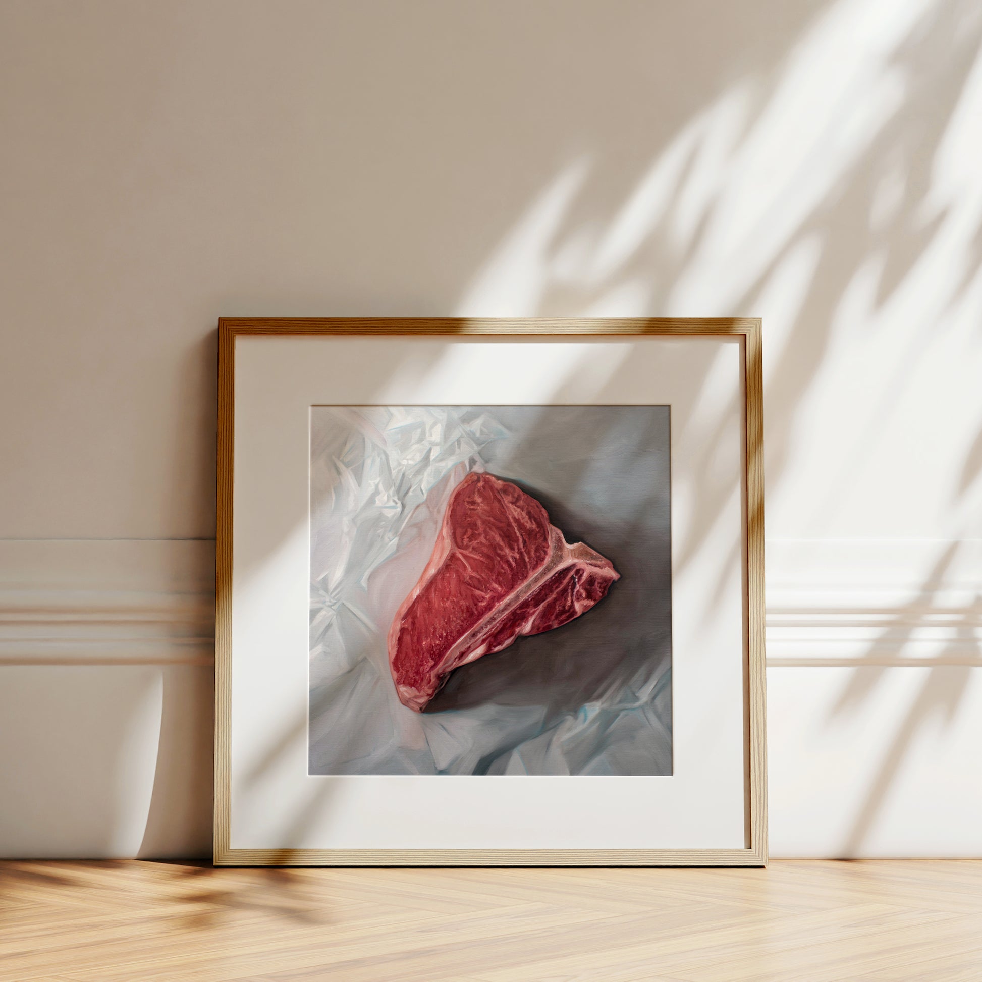 This artwork features a fresh t-bone resting upon a crinkled white wax paper sheet.
