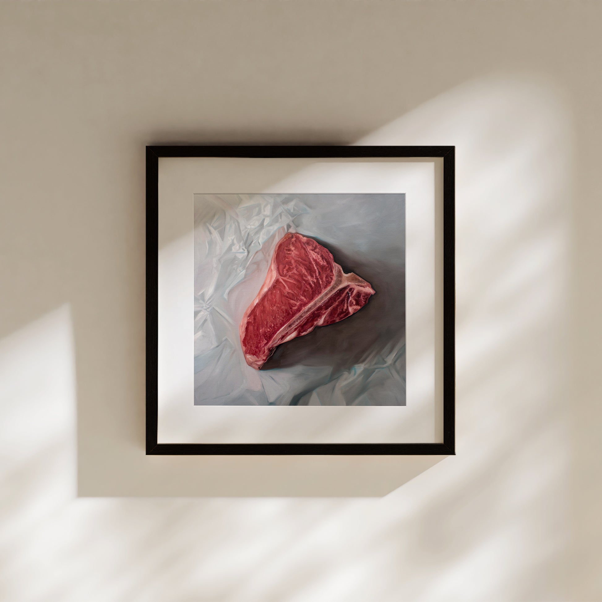 This artwork features a fresh t-bone resting upon a crinkled white wax paper sheet.