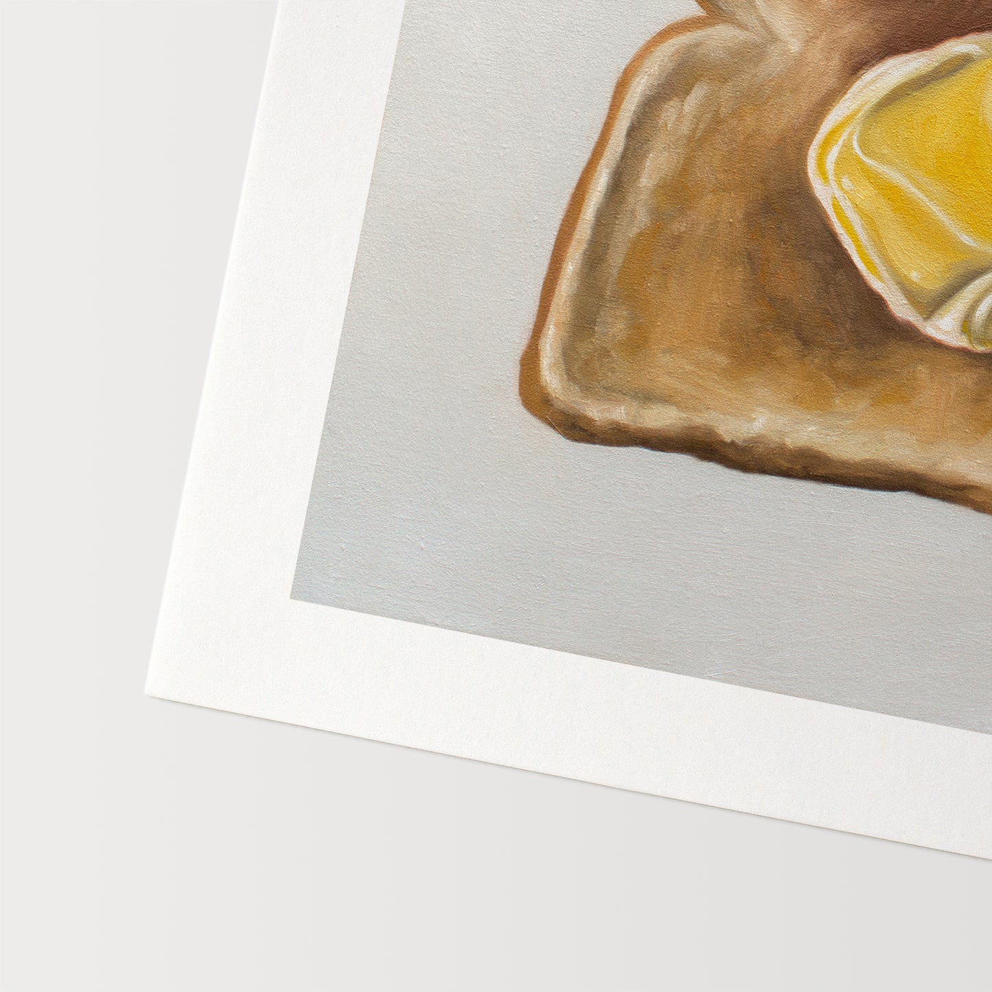 This artwork features a piece of freshly toasted bread with a nice dollop of butter.