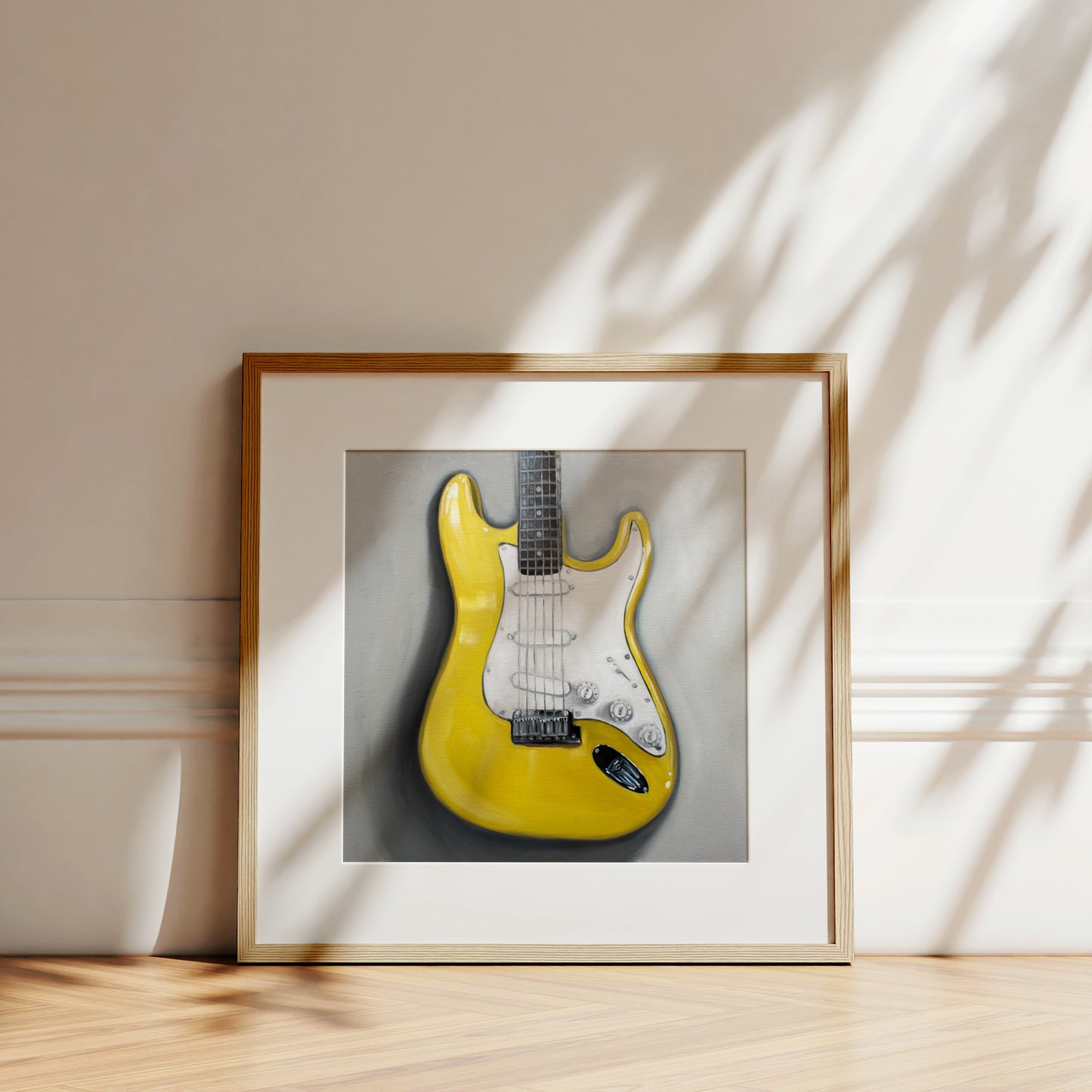 This artwork features a close up view of a bright yellow Stratocaster Guitar resting on a light grey surface.