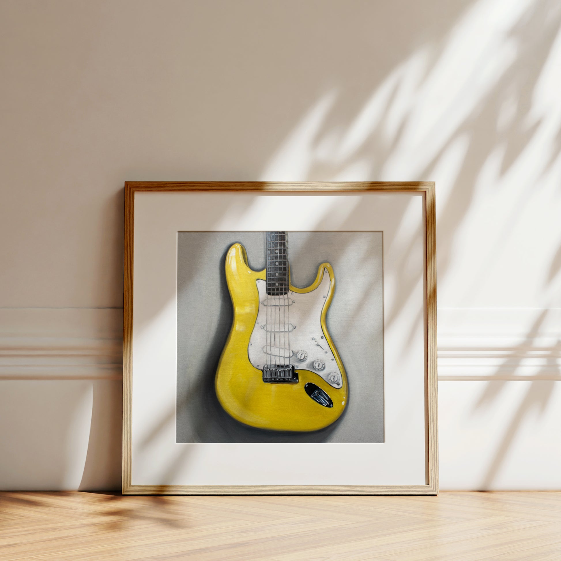 This artwork features a close up view of a bright yellow Stratocaster Guitar resting on a light grey surface.