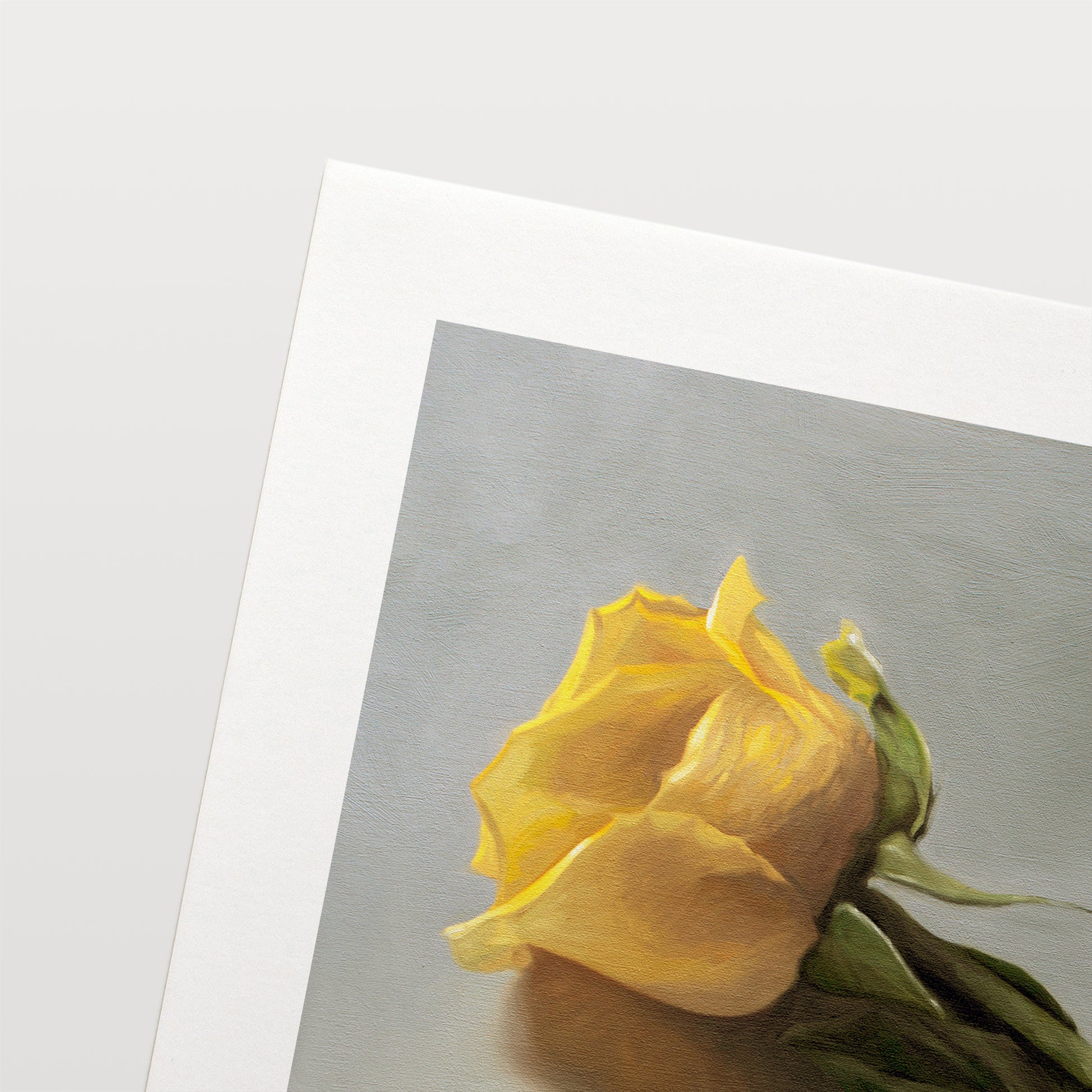 This artwork features a single yellow rose and petal laying on its side.