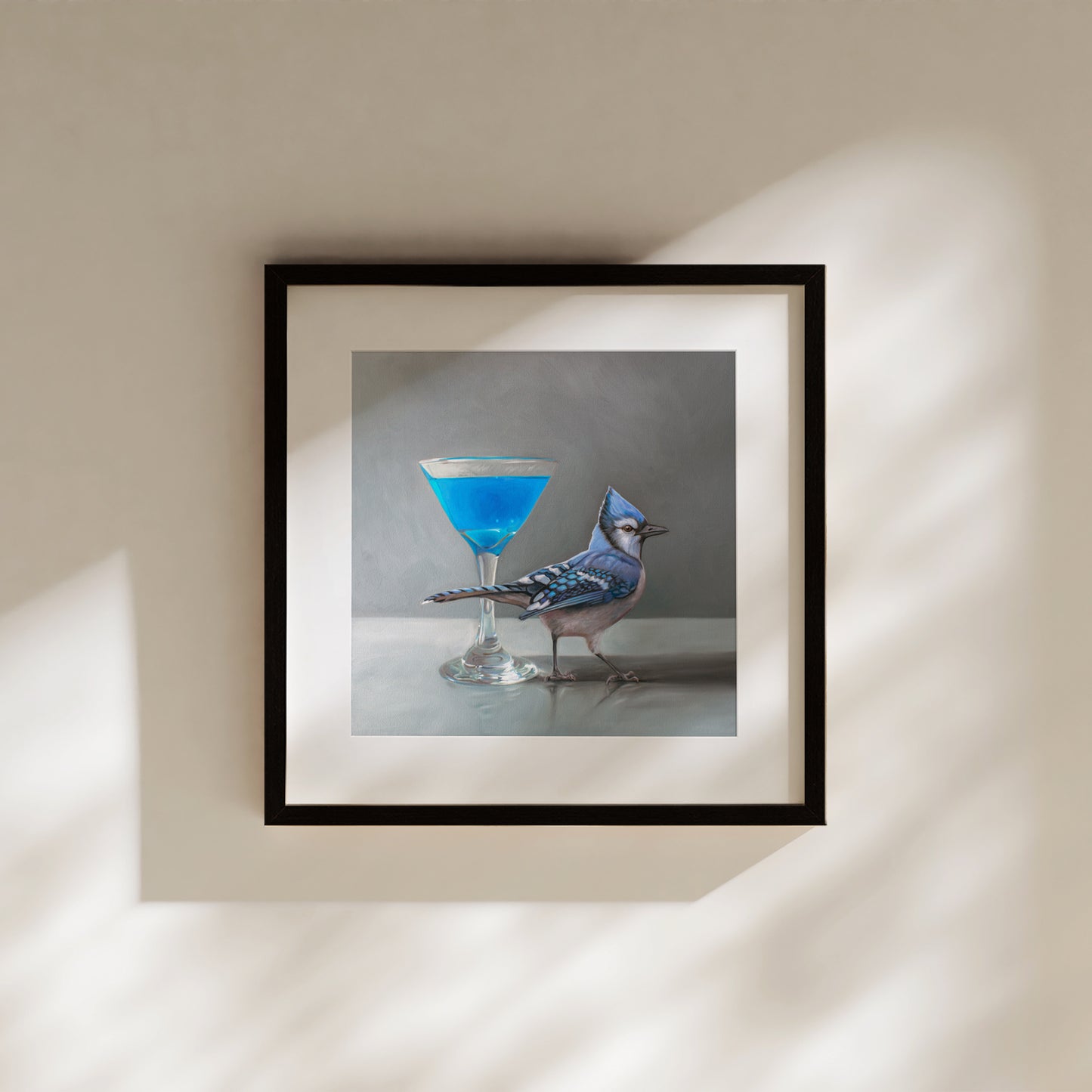 Framed fine art print of a vibrant blue martini and a blue jay on museum-grade paper.
