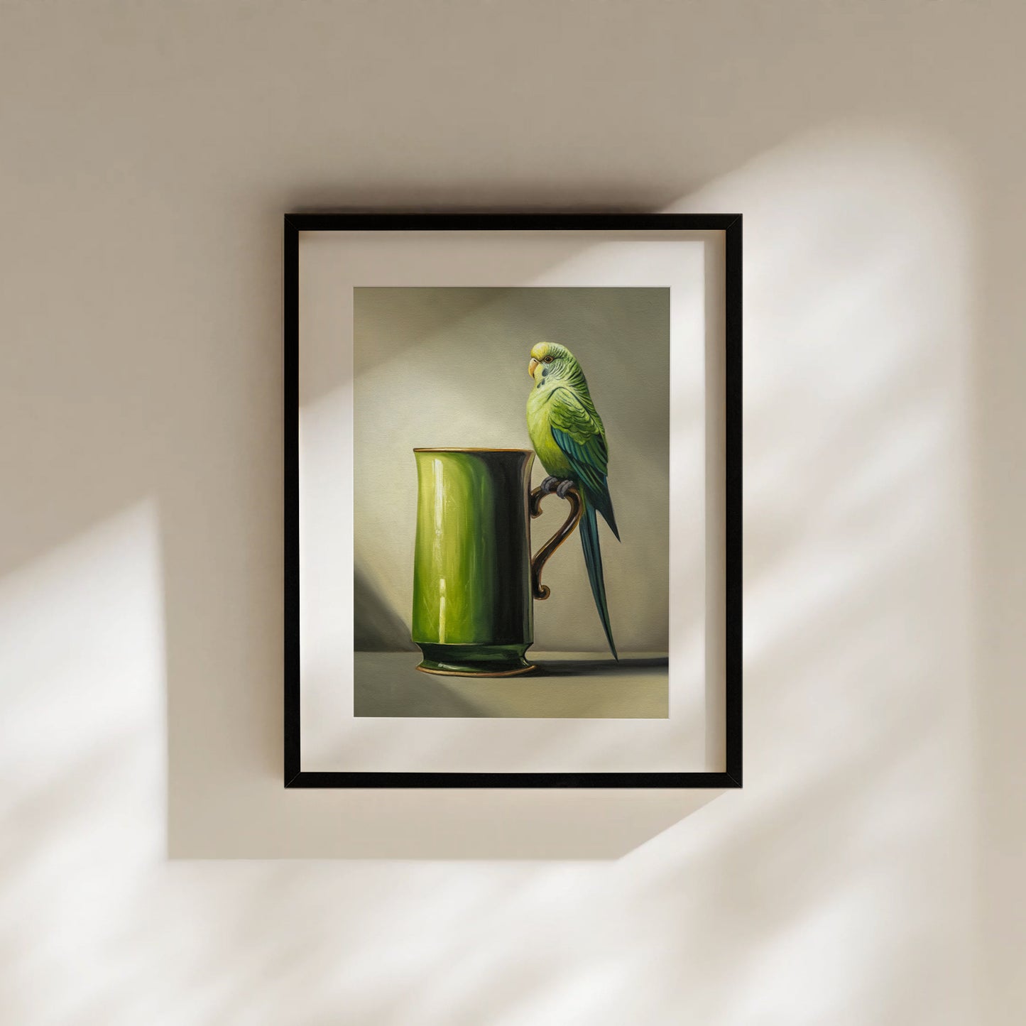 Framed fine art print of a green budgie perched on a vibrant green mug, signed and stamped.