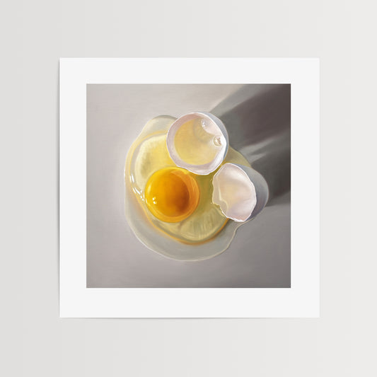 Cracked Egg Fine Art Print by Lauren Pretorius: a cracked egg resting on a light grey surface with some nice dramatic lighting.