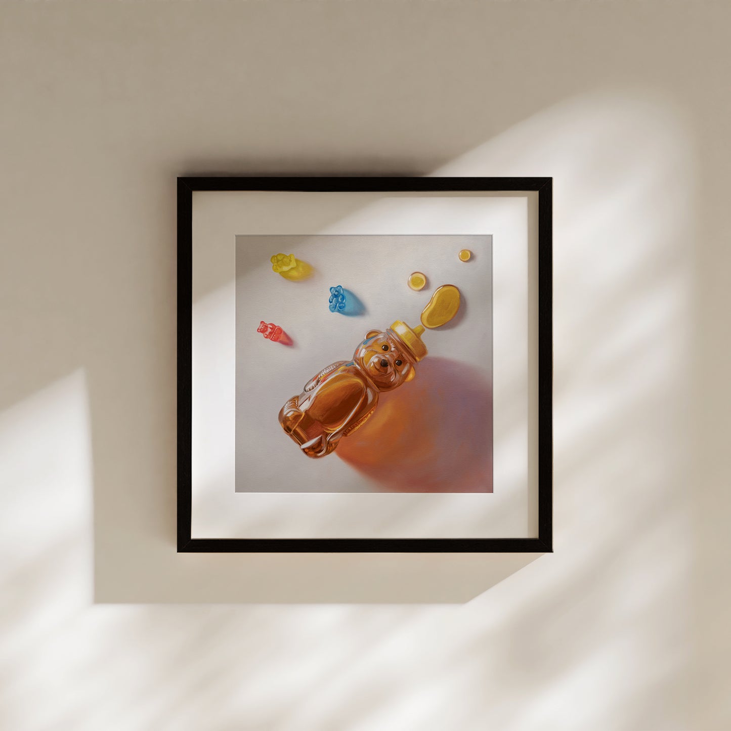 Framed fine art print of a honey bear bottle and colorful gummy bears on a white background.