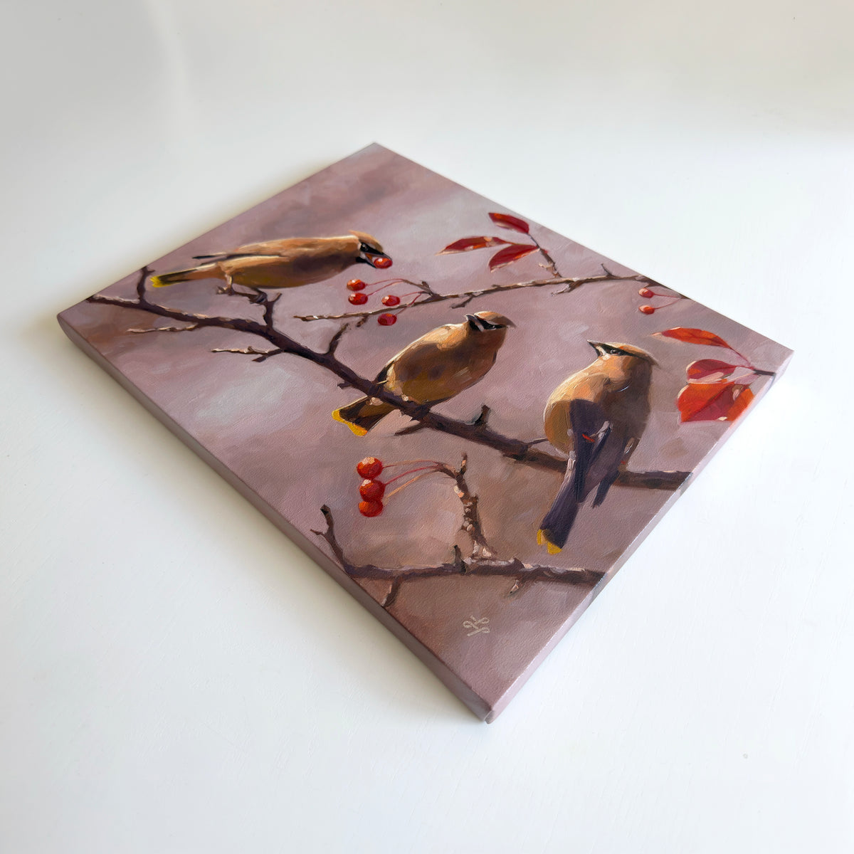 14x11 inch oil painting on linen featuring three Cedar Waxwings perched on branches with red berries against a soft mauve background.