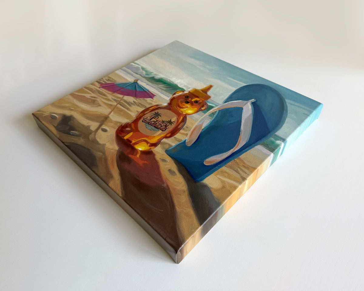 16x16 inch oil painting of a honey bear bottle on a sandy beach with a blue flip-flop and colorful umbrella.