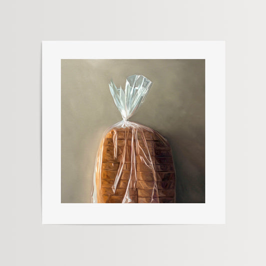 Loaf of Bread Fine Art Print by Lauren Pretorius: a fresh loaf of bread in clear plastic wrap on a light grey background.