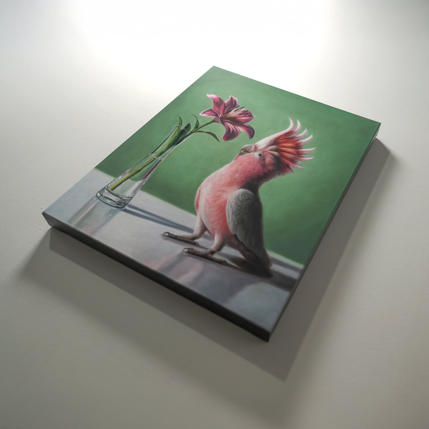 Mimicry in Pink 16" x 20" Original Oil Painting by Lauren Pretorius: a Pink cockatoo next to a pink Asiatic Lily flower in a clear vase on a green background