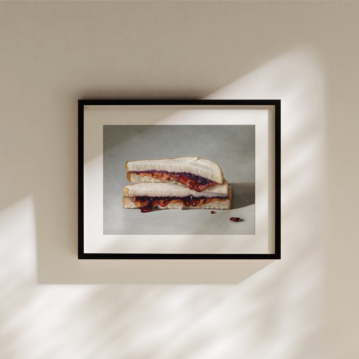 Framed fine art print of a peanut butter and jelly sandwich with two red pills on a light background.