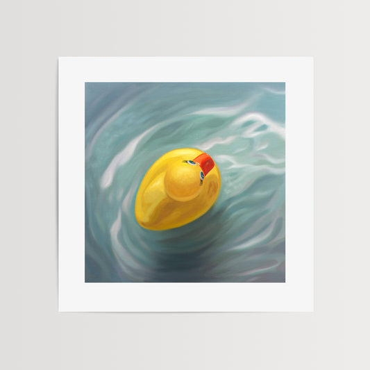Rubber Ducky Fine Art Print by Lauren Pretorius: a single rubber ducky floating in blue rippled water from above.