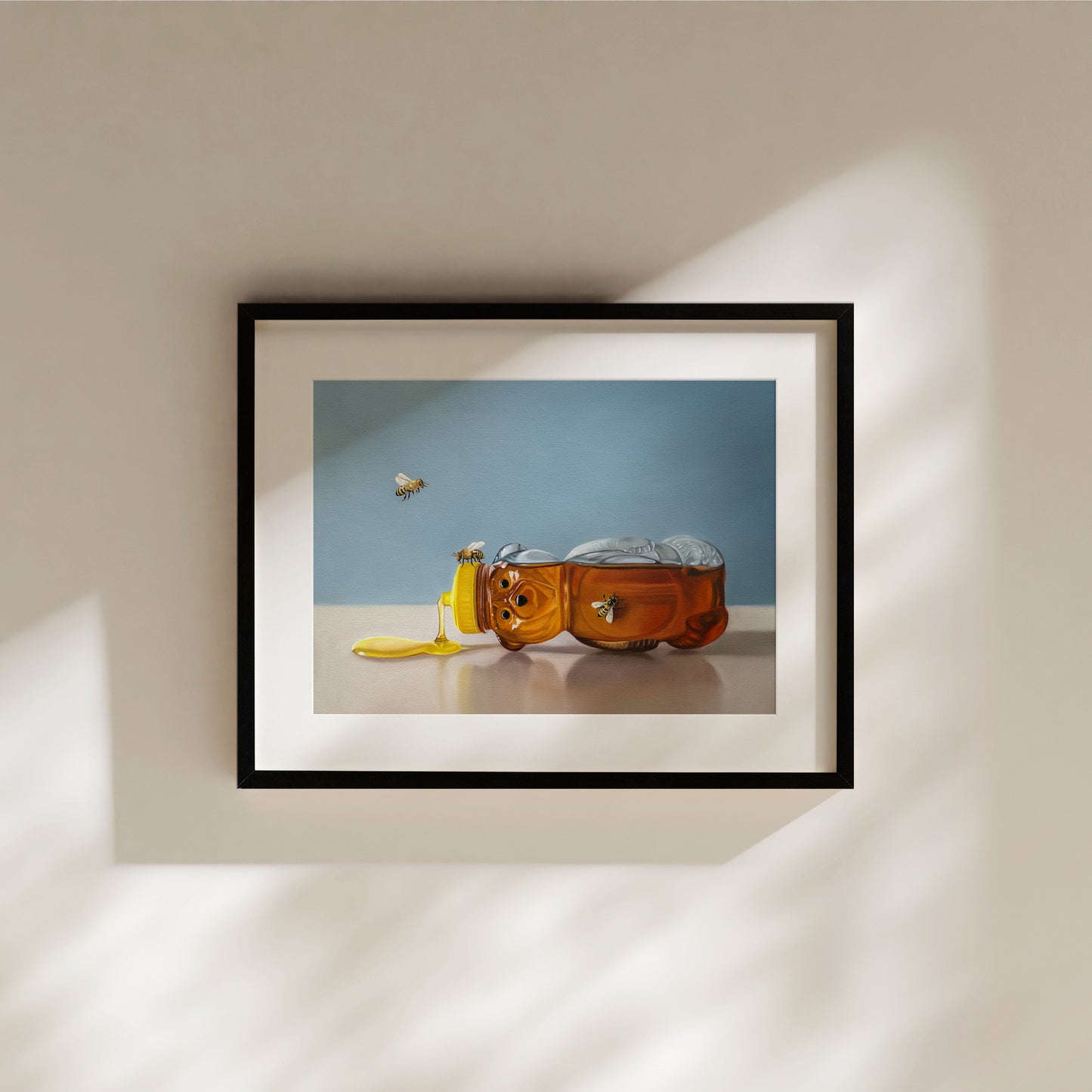 Framed fine art print of a honey bear bottle spilling golden honey with two bees flying.
