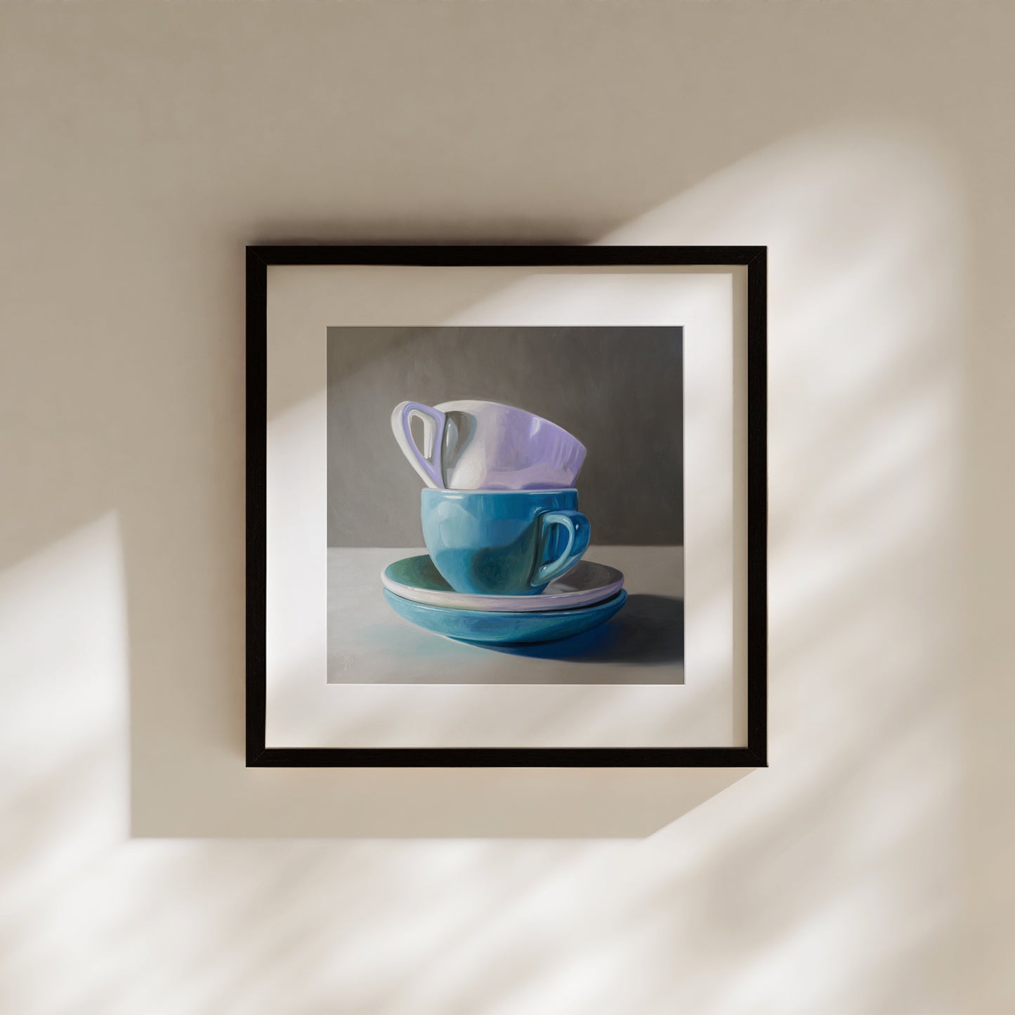 Stacked Cups & Saucers Fine Art Print by Lauren Pretorius: a stack of blue and white cups and saucers on a table.