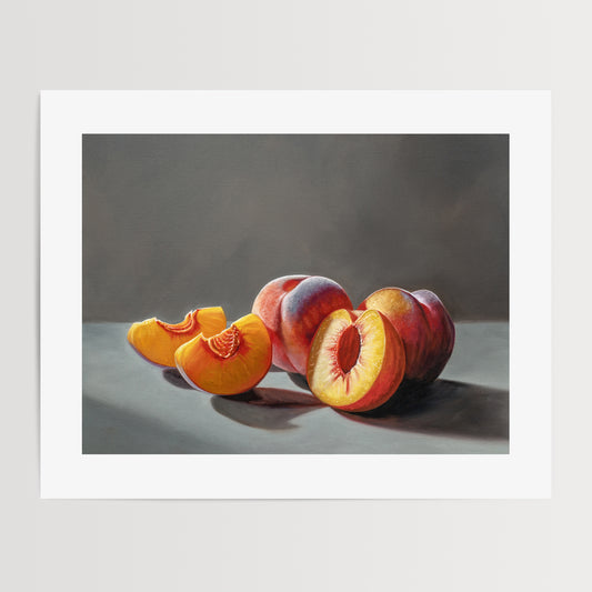 Sunlit Peaches Fine Art Print by Lauren Pretorius: a group of sliced and whole peaches in dramatic lighting on a grey backdrop.