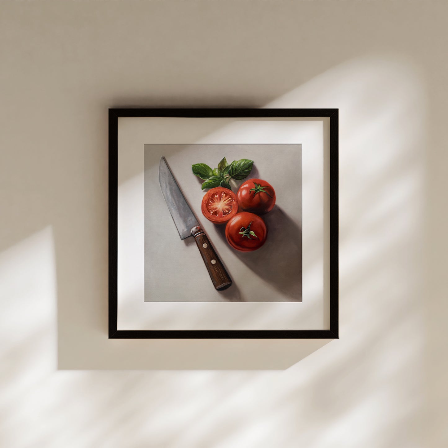 Tomato & Basil Fine Art Print by Lauren Pretorius: a knife next to three tomatoes and basil leaves on a light surface