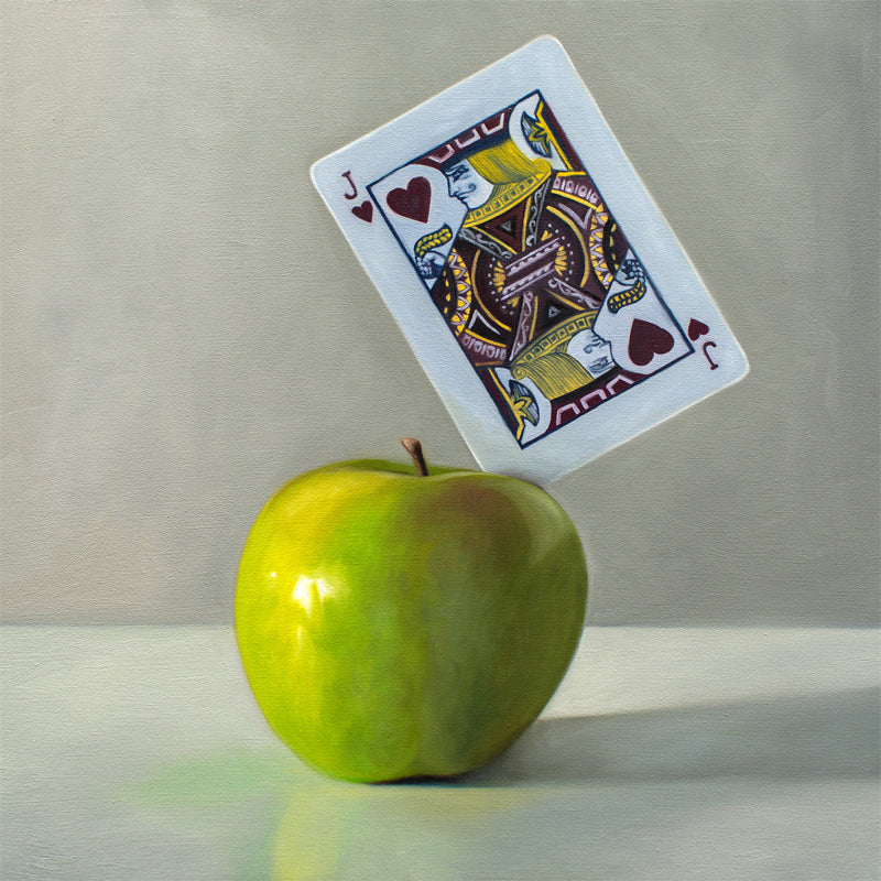 This artwork features a pun on the word ‘Applejack’. A Jack of Hearts playing card is embedded in the upper right corner of a bright green granny smith apple.