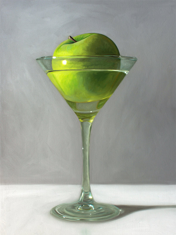 This artwork features a whimsical take on the traditional Apple Martini cocktail. A single granny smith apple rests inside a martini glass on a light, reflective surface with dramatic light and shadows.