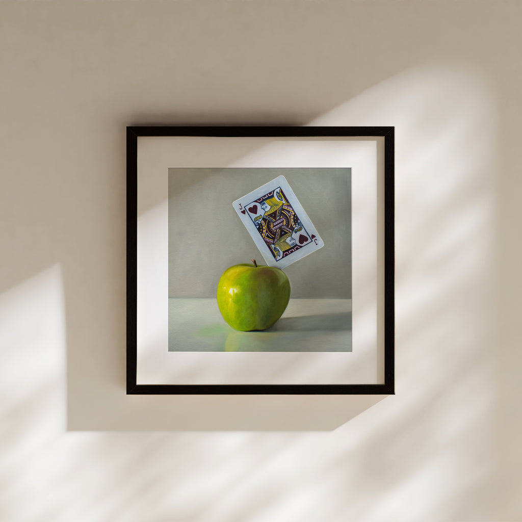 This artwork features a pun on the word ‘Applejack’. A Jack of Hearts playing card is embedded in the upper right corner of a bright green granny smith apple.
