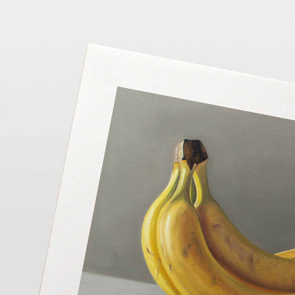 This artwork features a bunch of bananas resting on a light surface.