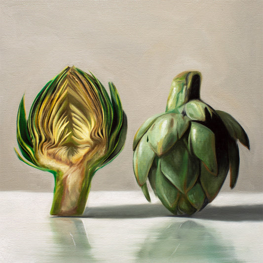 This artwork features an artichoke sliced in half an strategically placed on a light reflective surface.