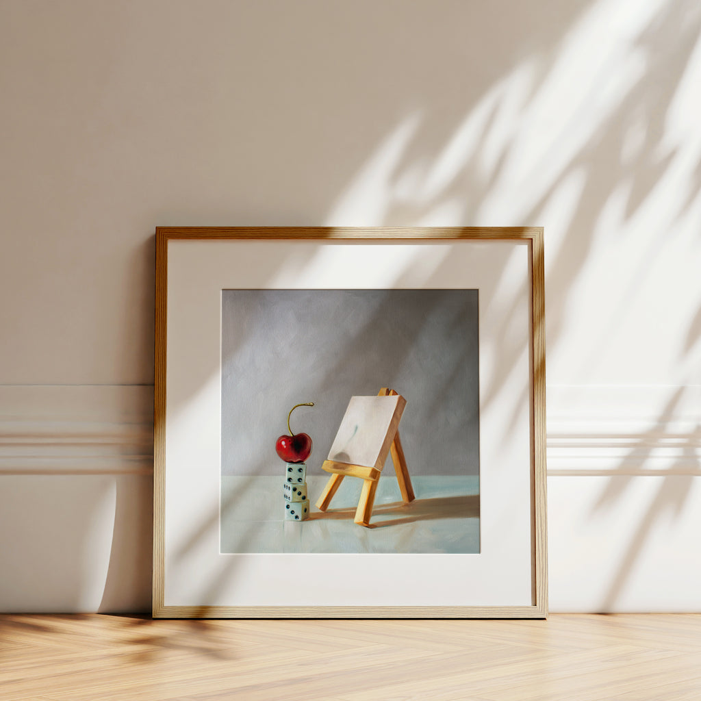 This artwork features a bright red cherry in front of a mini blank canvas on a mini easel seemingly having a case of ‘Artist’s Block’.It goes without saying that all artists can almost certainly relate to the little guy!