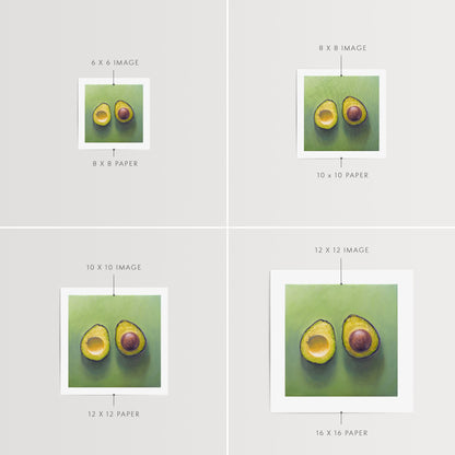 This artwork features a freshly sliced avocado resting on a matching green surface with some nice dramatic lighting.