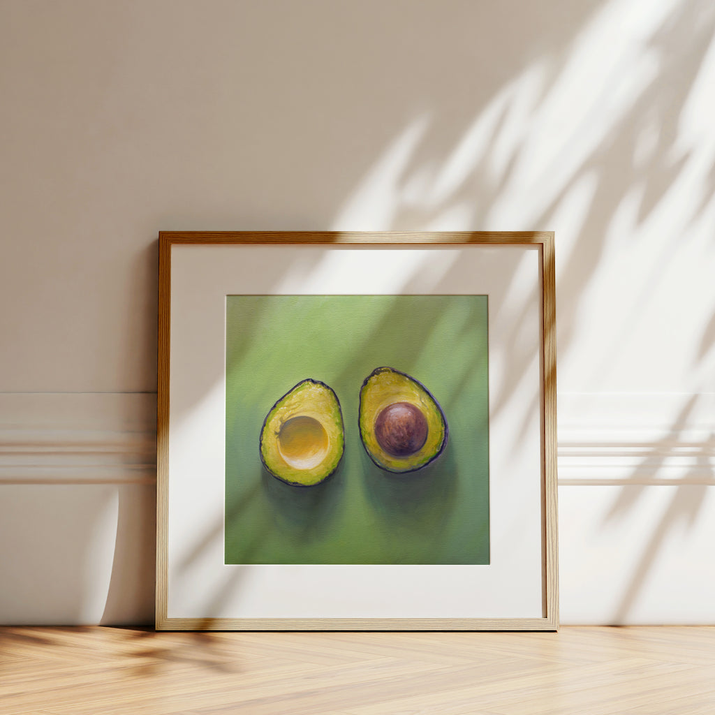 This artwork features a freshly sliced avocado resting on a matching green surface with some nice dramatic lighting.