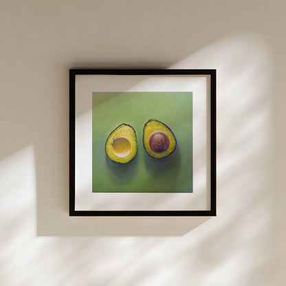 This artwork features a freshly sliced avocado resting on a matching green surface with some nice dramatic lighting.