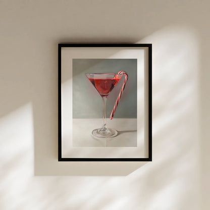 This artwork features a Christmas candy cane resting on the lip of a martini.