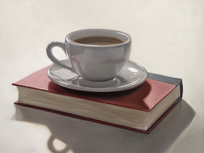 This artwork features a backlit coffee cup and saucer resting on top of a red book.