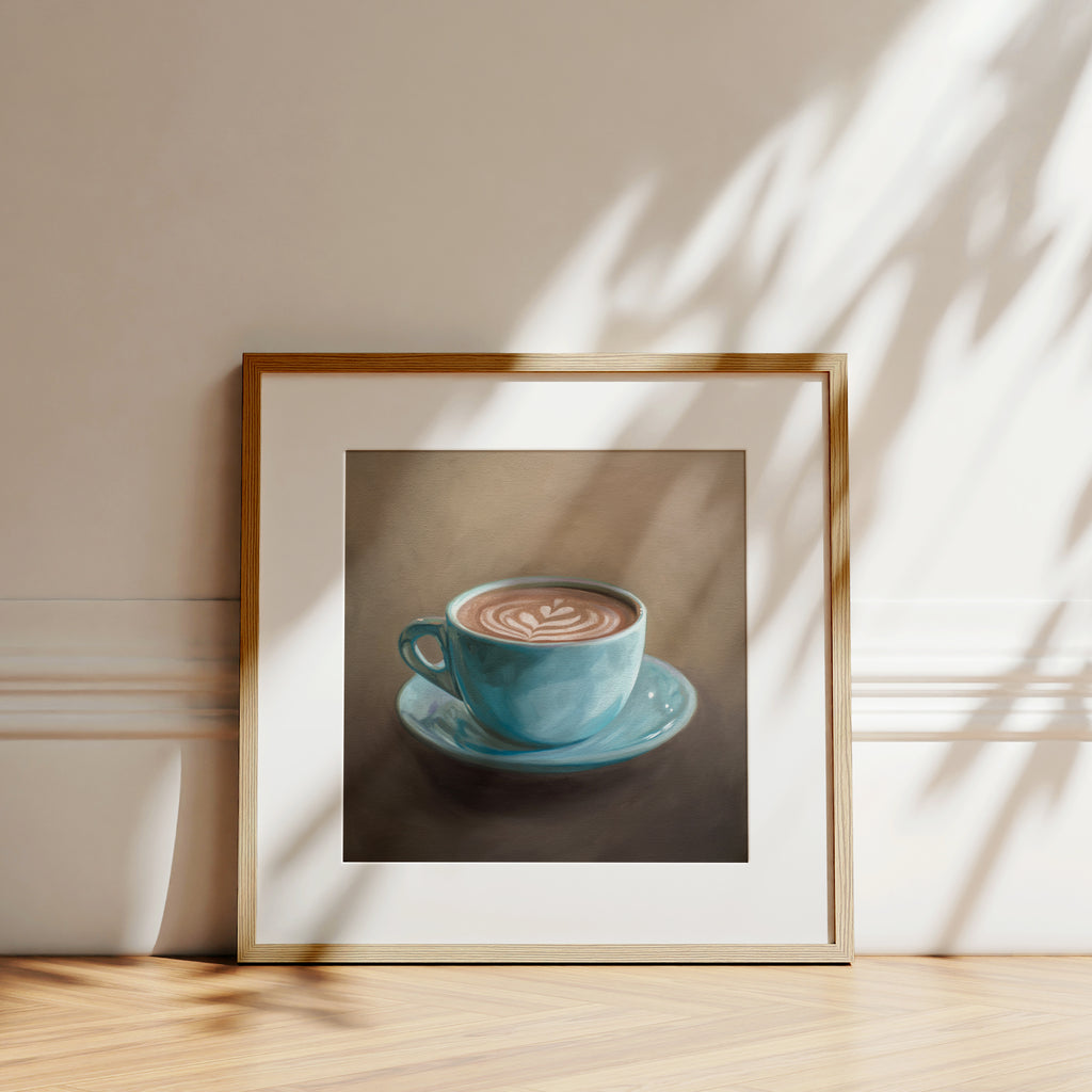 This artwork features a single blue coffee cup filled to the brim lan artful latte.