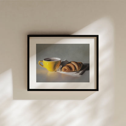 This artwork features a yellow cup of coffee and fresh croissant on a napkin.