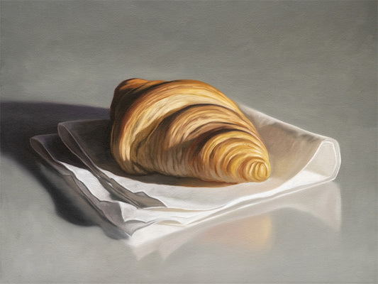 This artwork features a single freshly baked croissant resting on a napkin on a reflective surface.