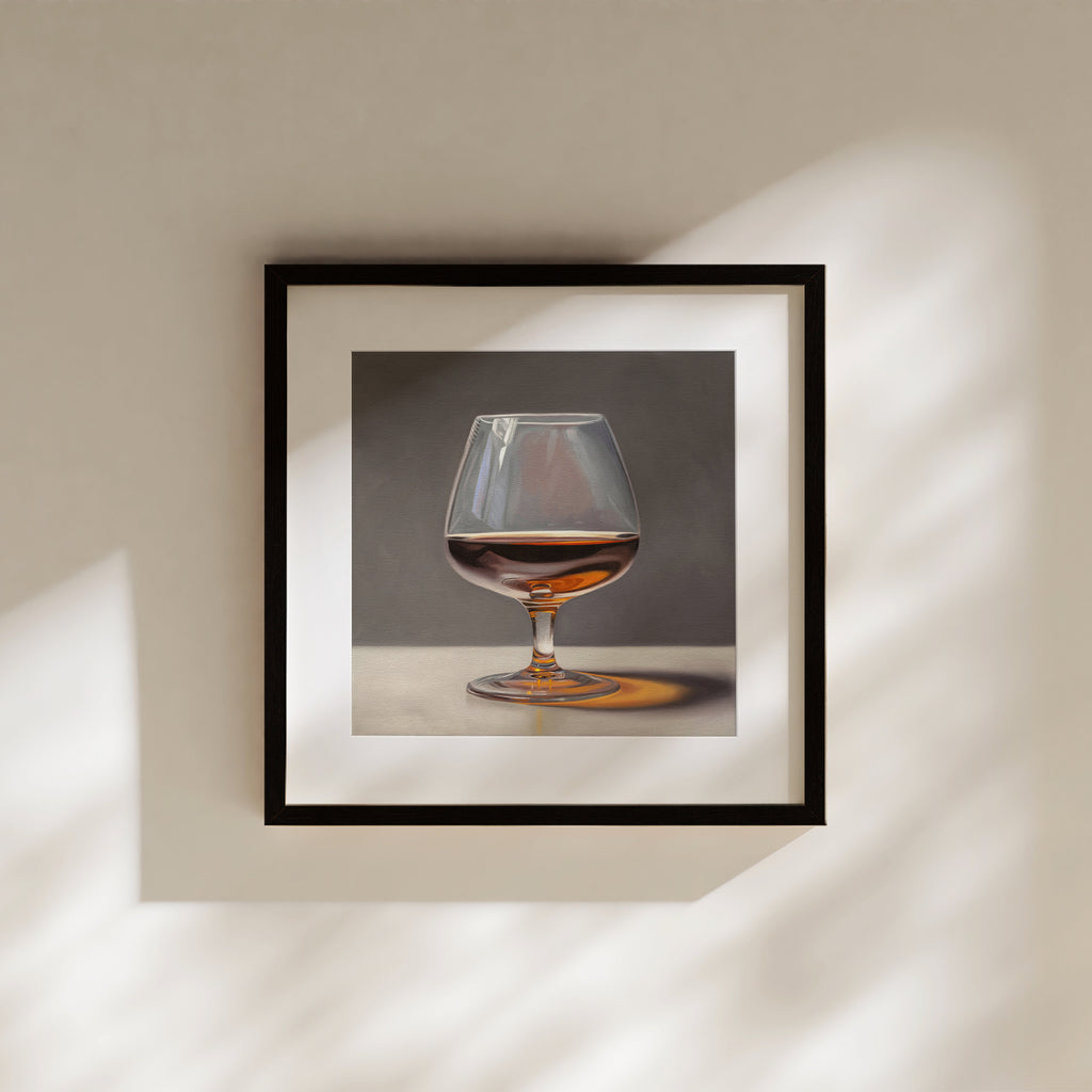 This artwork features a glass of brandy resting on a light surface with some nice dramatic lighting.