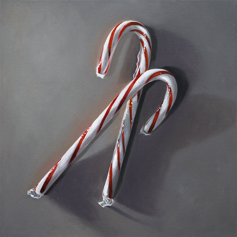 This artwork features a pair of candy canes resting on a dark grey surface with dramatic side lighting.
