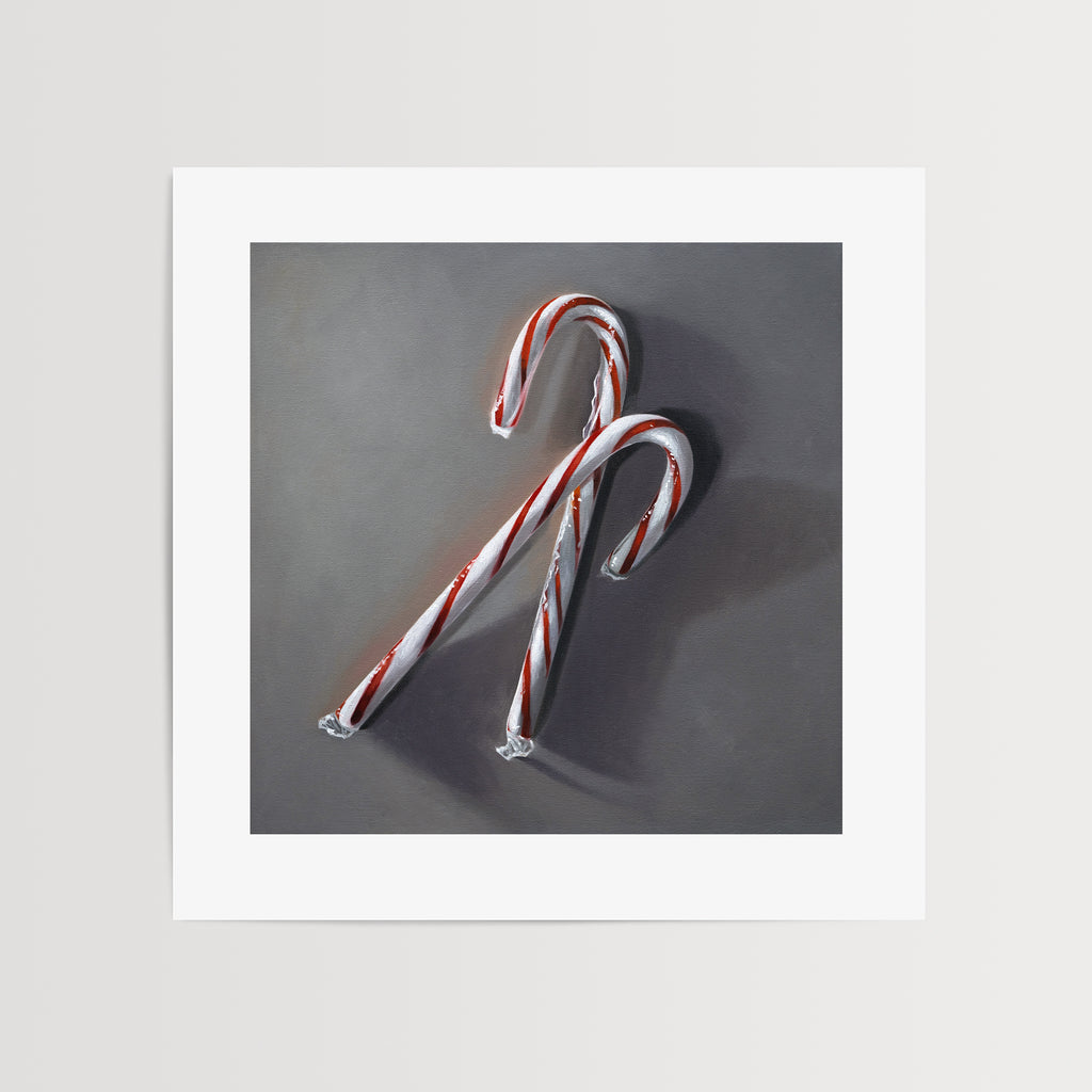 This artwork features a pair of candy canes resting on a dark grey surface with dramatic side lighting.