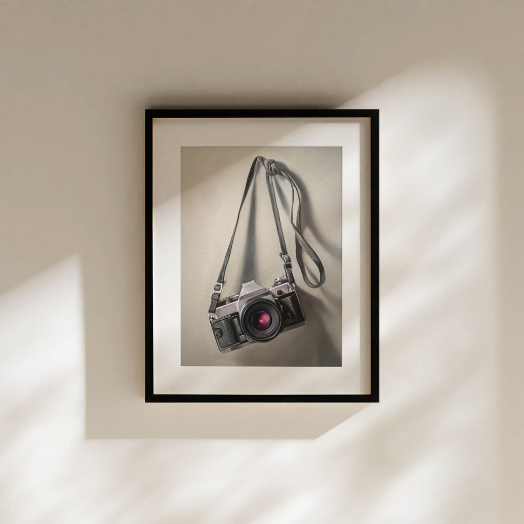This artwork features a vintage 35mm camera hanging from its strap with some nice dramatic lighting.