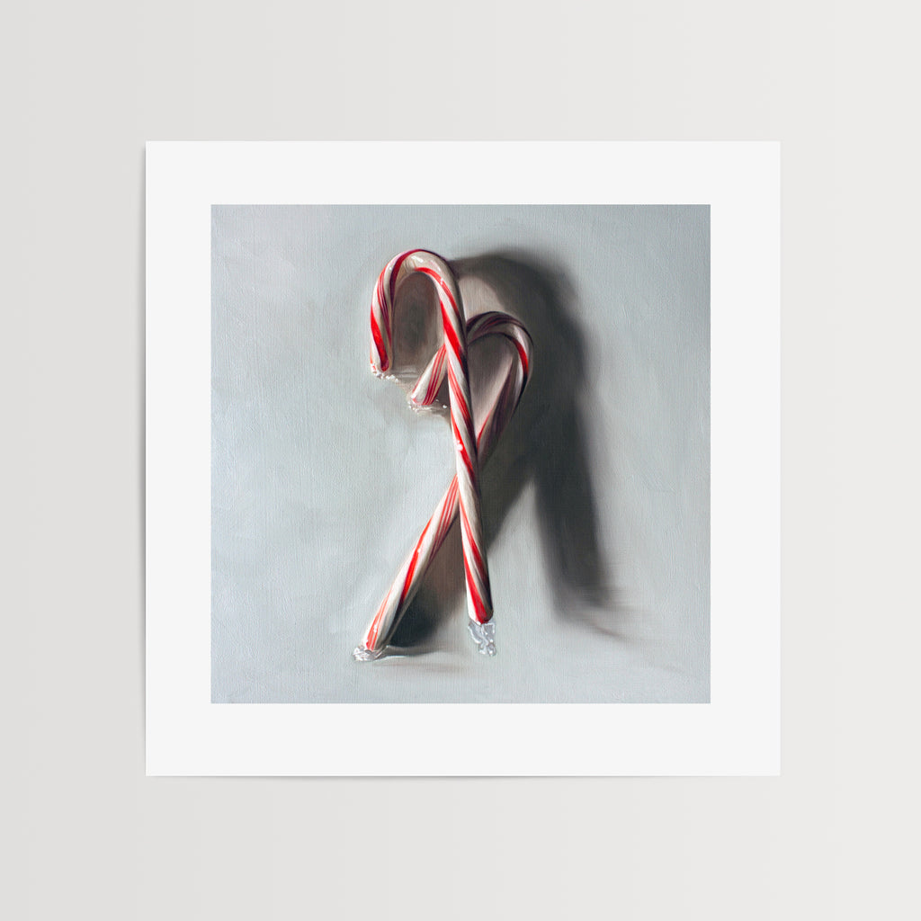 This artwork features a pair of candy canes resting on a light grey surface with dramatic side light.