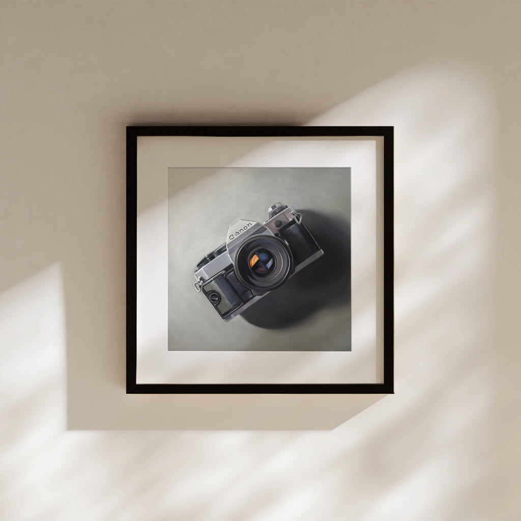 This oil painting features a vintage Canon AE-1 camera resting on a neutral surface with dramatic side lighting.