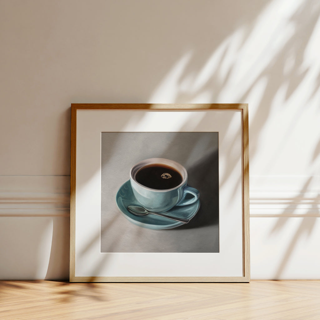This artwork features a light blue cup of coffee resting on a saucer with a spoon..