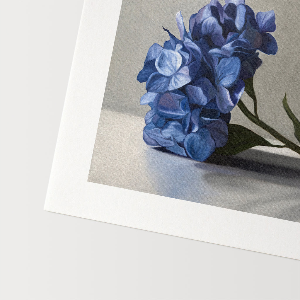 This artwork features a bouquet of blue hydrangeas resting on a light surface with a neutral background.