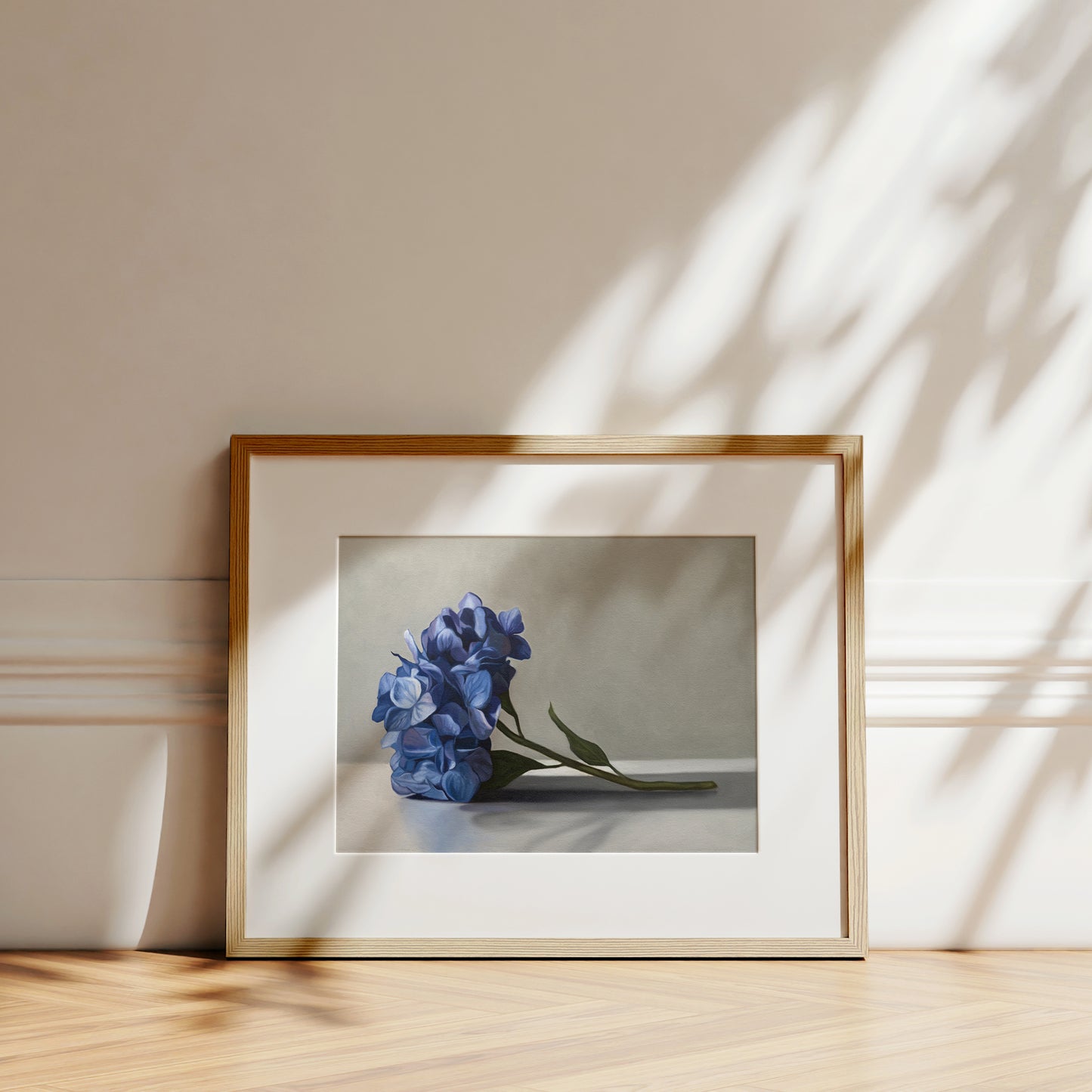 This artwork features a bouquet of blue hydrangeas resting on a light surface with a neutral background.