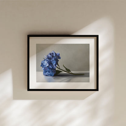 This artwork features a bouquet of blue hydrangeas resting on a light surface with a neutral background.