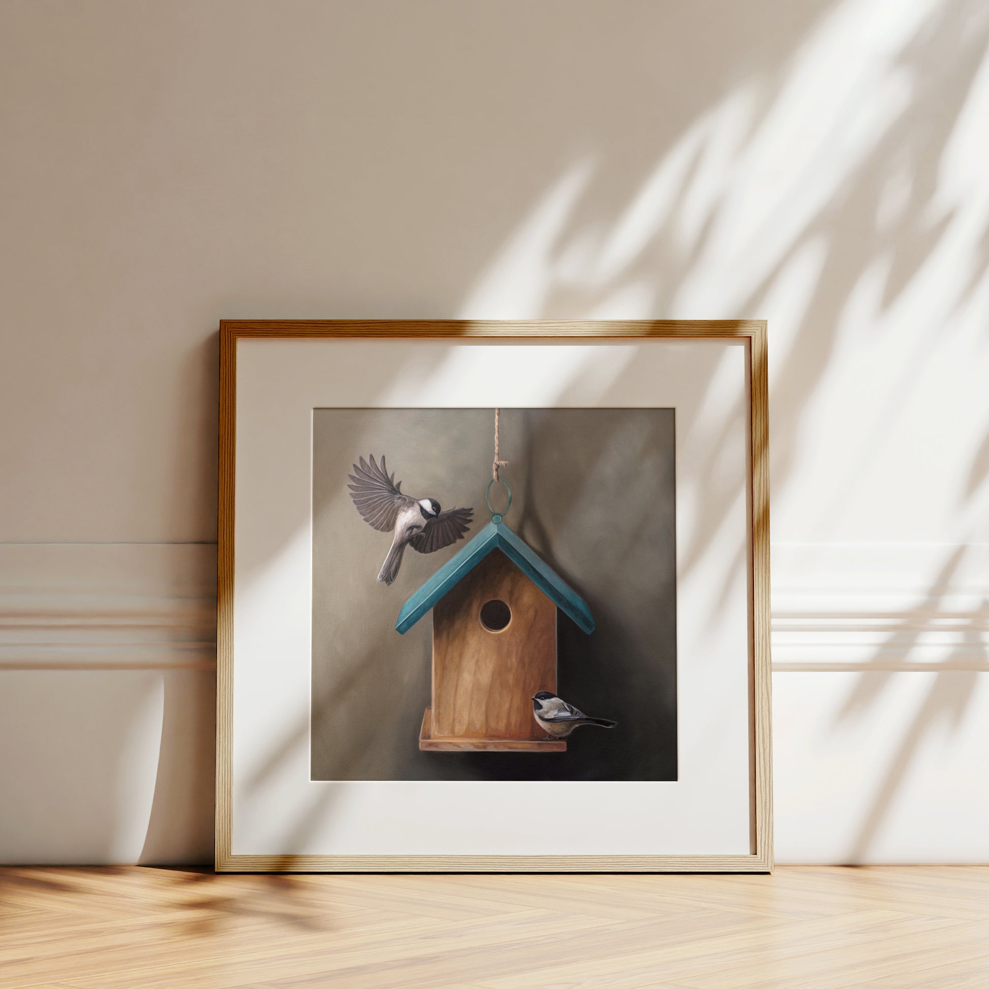 This artwork features a pair of chickadees inspecting a cute little birdhouse with a blue roof.