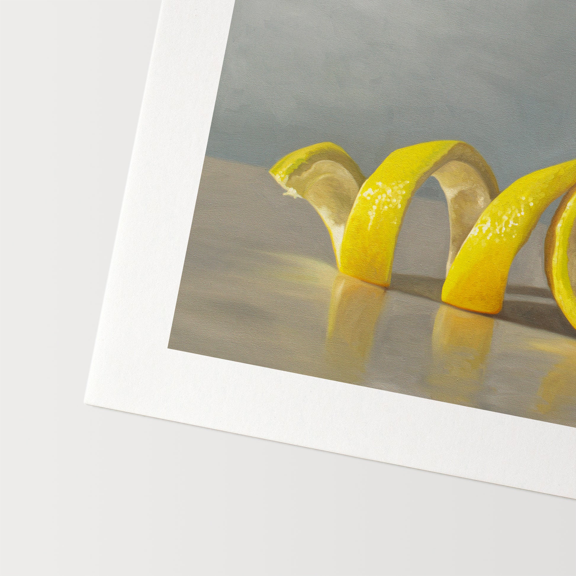 This artwork features a lemon half with its peeling spiraling out towards the left on a light, reflective surface and muted blue background.