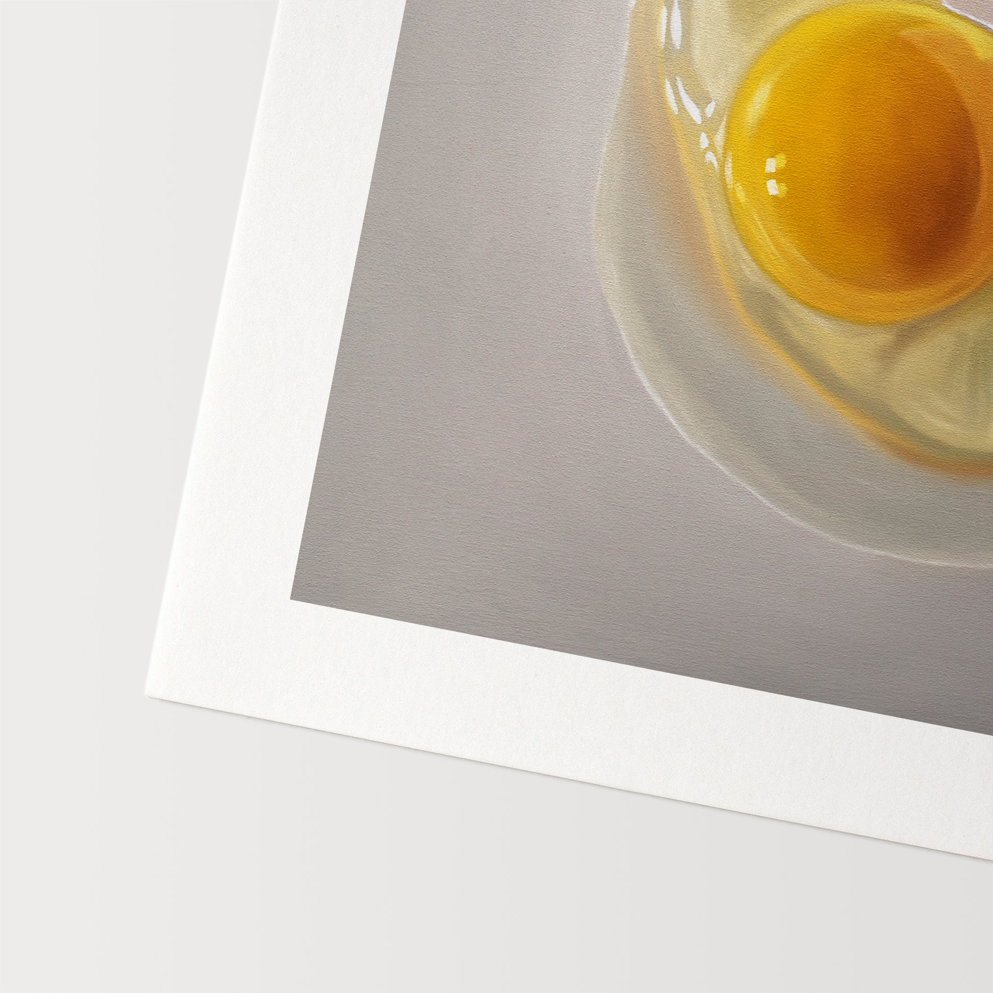 This artwork features a cracked egg resting on a light grey surface with some nice dramatic lighting.