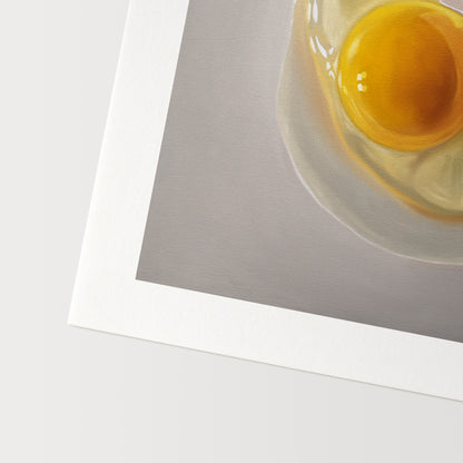 This artwork features a cracked egg resting on a light grey surface with some nice dramatic lighting.